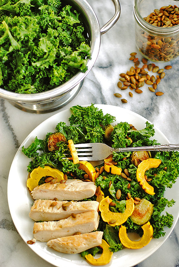 Delicata squash and kale salad with chicken and toasted pumpkin seeds - you are going to want this delicious salad before your week is over. The roasted squash you don't have to peel and the simple ingredients of kale, brussels, pumpkin seeds and mustard vinaigrette make it a recipe to keep. Change up different vegetables, add chicken if you want. | shemadeitshemight.com