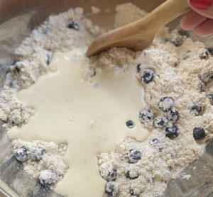 bowl of cream and blueberry scone dough ready to mix