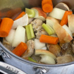 stockpot of carrots, celery, onions, chicken frying