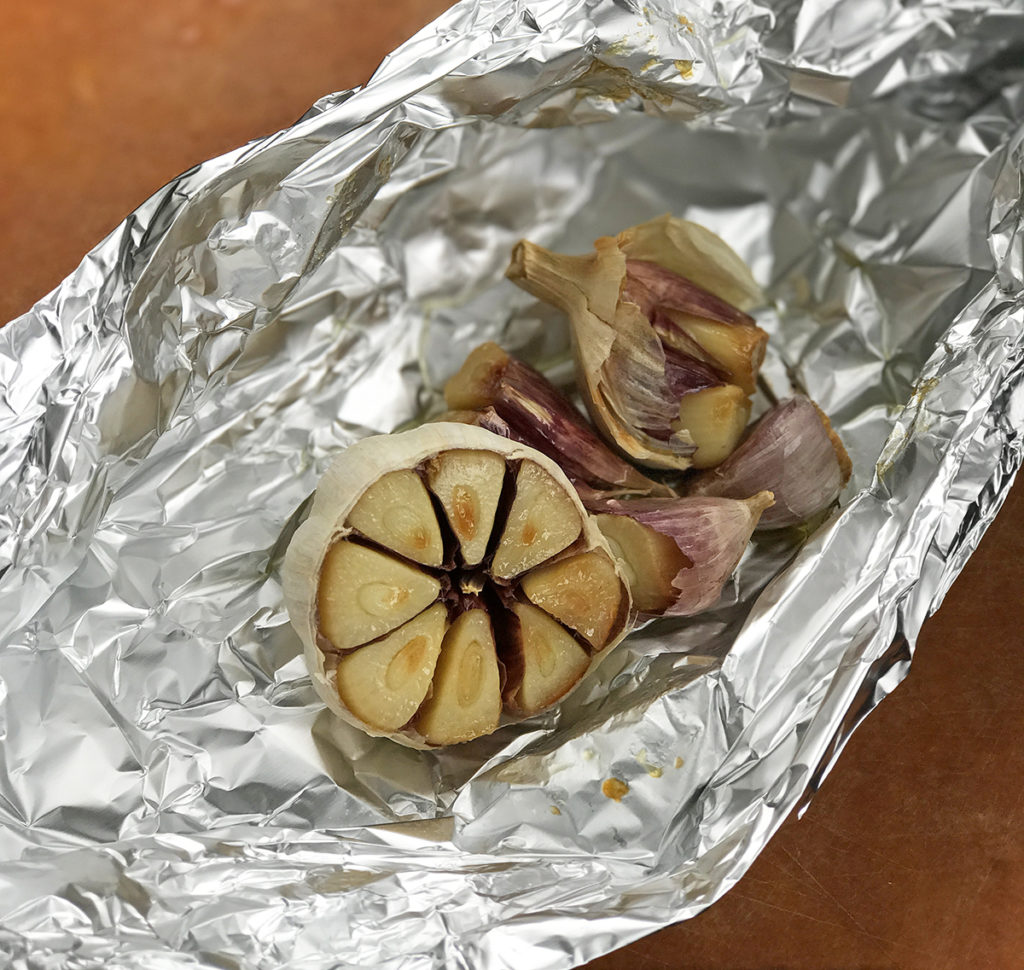 Foil open with roasted garlic cloves for poblano sauce recipe. 