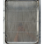Mirrored baking sheet with cooling rack sitting inside on a marble counter.