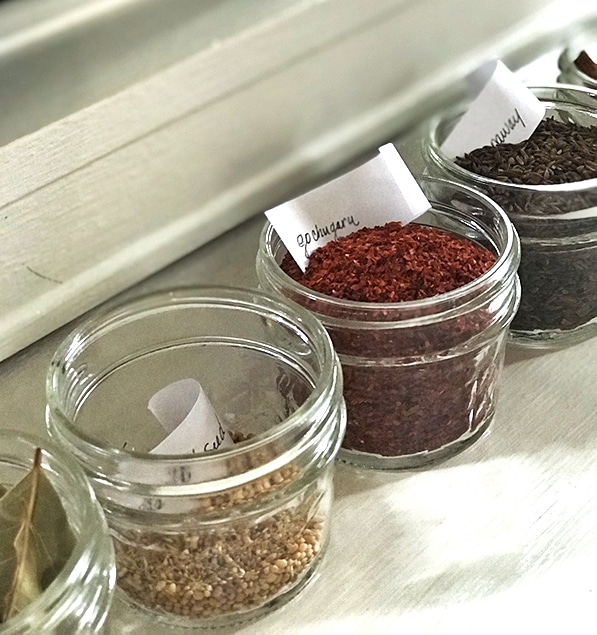 4 oz mini mason jars holding spices and one is title gochugaru with a tiny white slip of paper