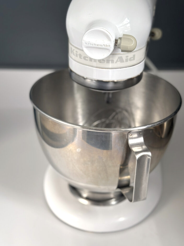 white kitchen aid mixer with silver bowl