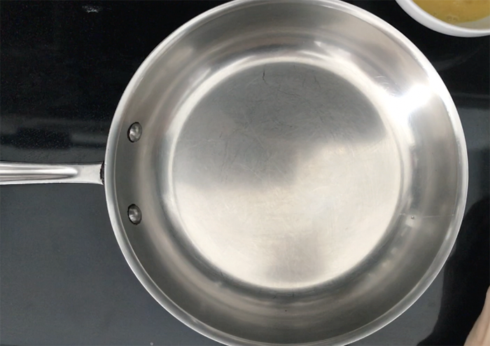 Empty stainless steel pan preheating for scrambled eggs