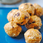 Close-up of oat and nut butter energy bites with oats and mini chocolate chips – no-bake protein snack recipe.