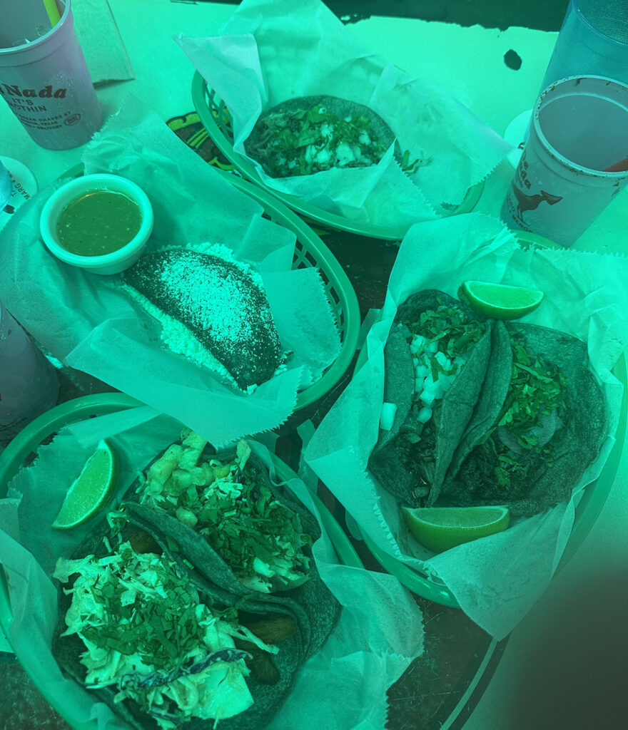 Blue corn fish, shrimp, and mushroom tacos with lime wedges in baskets at De Nada in Austin